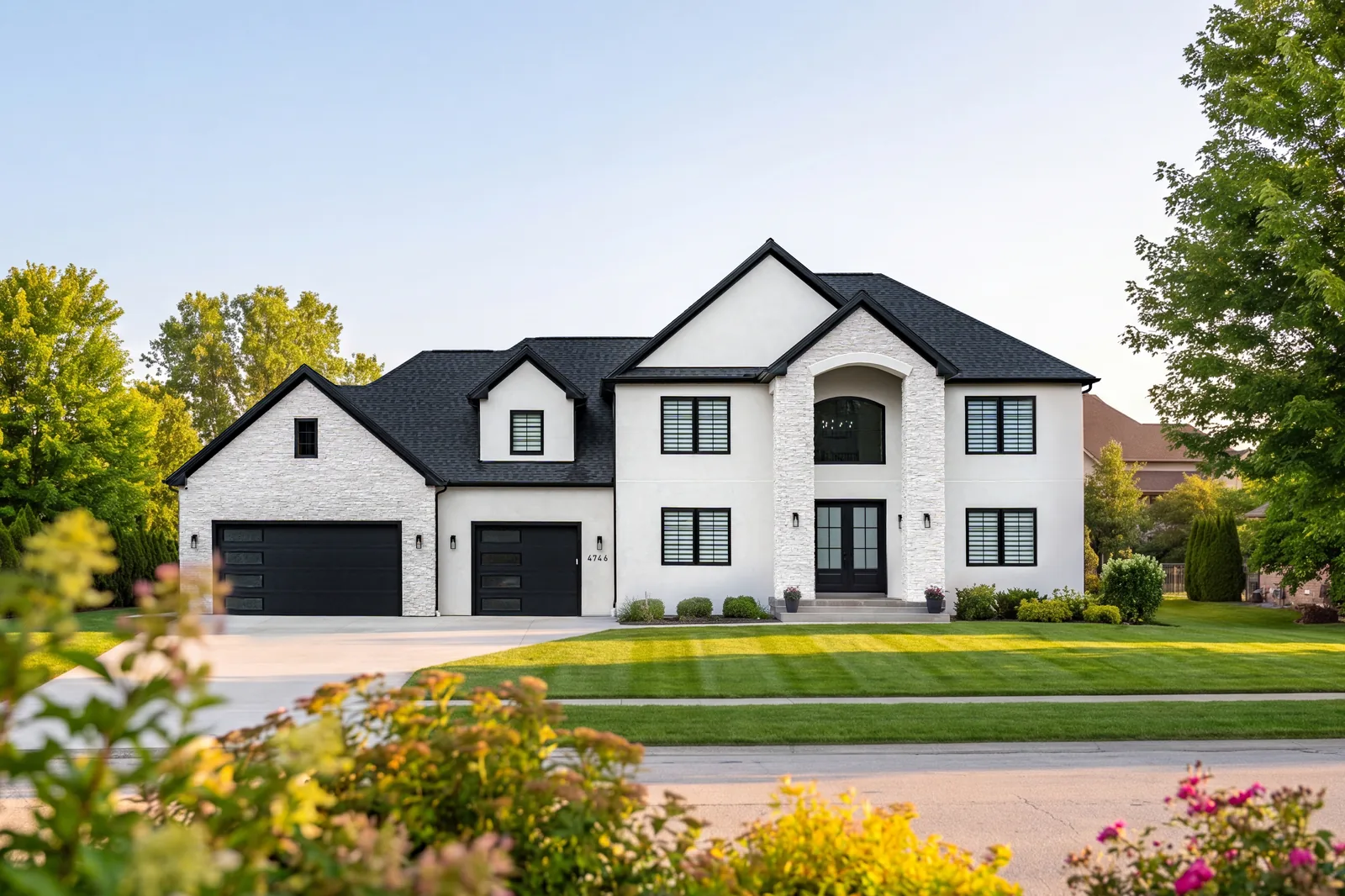 Birchwood Residence — Front exterior with flowering landscaping