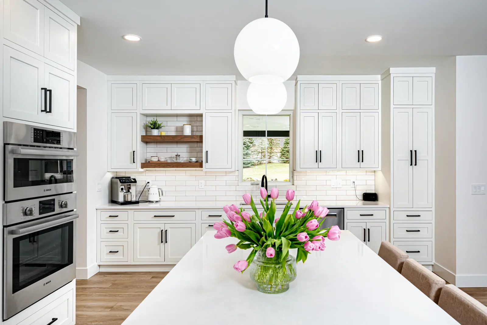Birchwood Residence — Kitchen island with fresh flowers