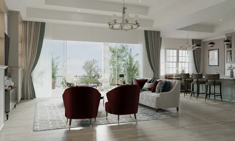 Open-plan living room with burgundy armchairs, a white sofa, and a kitchen beside large patio windows.